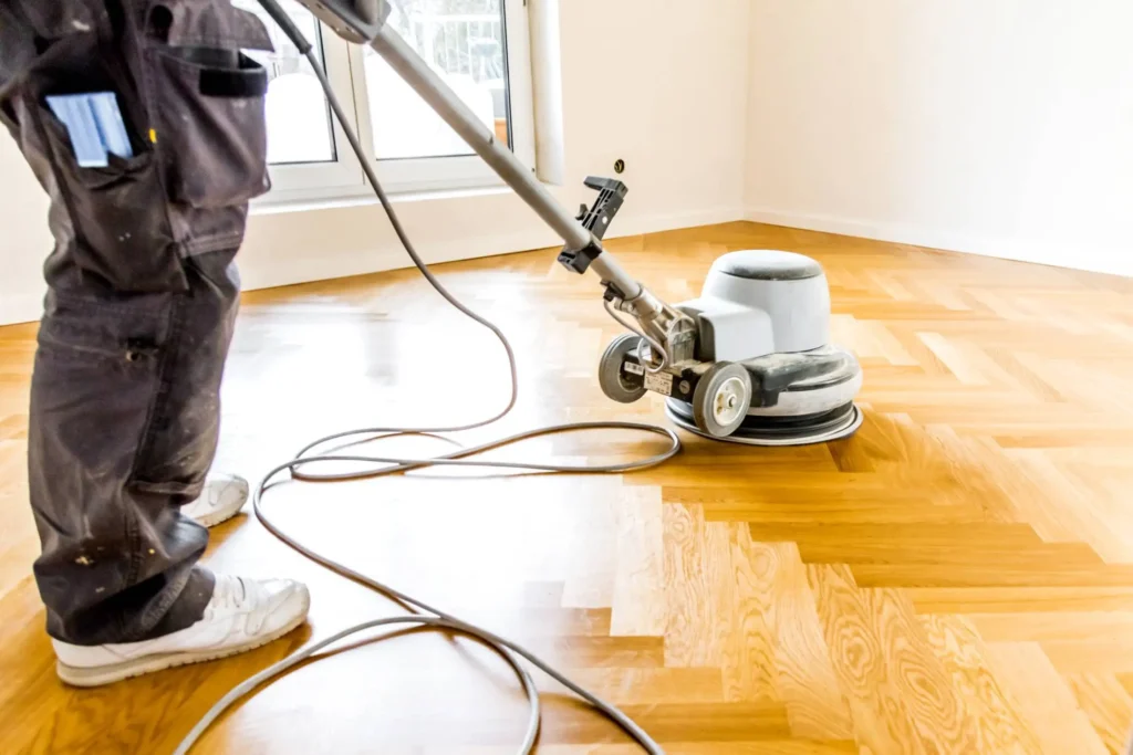The worker is resurfacing the floor in Albany, NY.