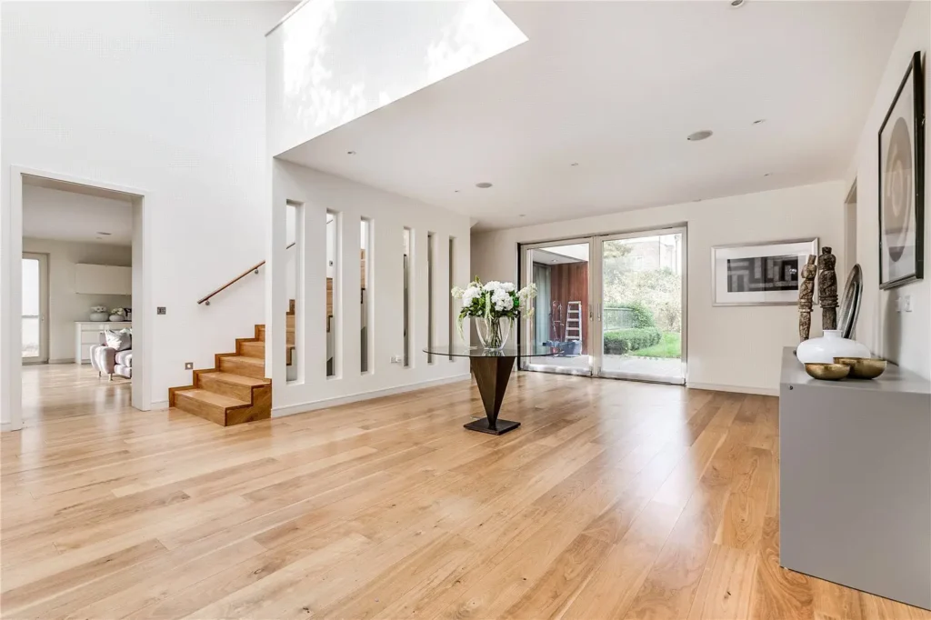 Refinished hardwood floors in a modern Albany, NY home, featuring a bright, open space with natural light and elegant decor.
